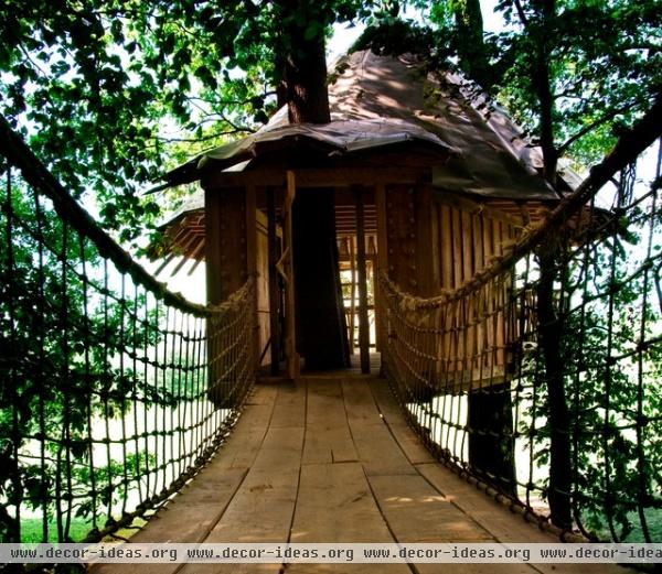 tropical garage and shed by Hugh Lofting Timber Framing, Inc.