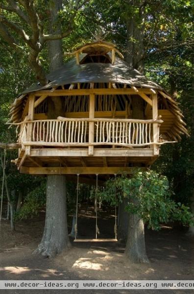 tropical garage and shed by Hugh Lofting Timber Framing, Inc.