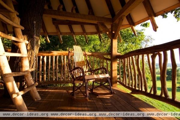 tropical porch by Hugh Lofting Timber Framing, Inc.