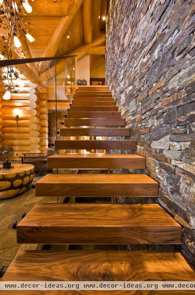 rustic staircase by Sticks and Stones Design Group Inc