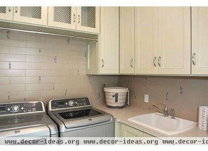 transitional laundry room by Dwellings