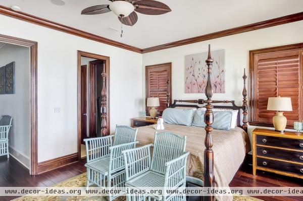 tropical bedroom by Emerald Coast Real Estate Photography