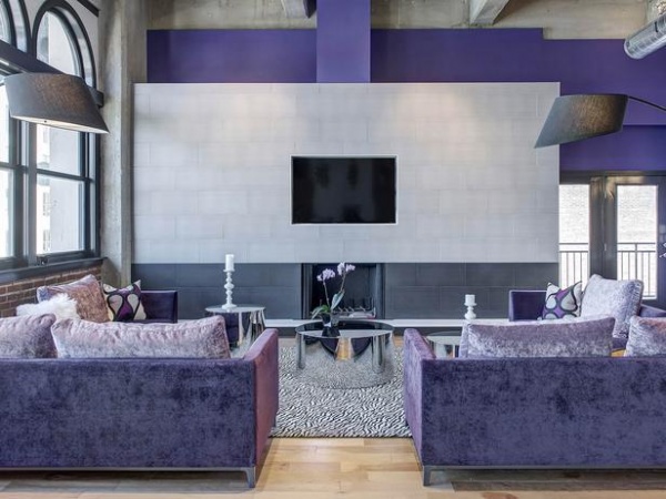 Downtown Loft Living Room with Chic Lavender Sofas and Exposed Ductwork : Designers' Portfolio