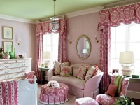 Pink and Green Girls Bedroom with Upholstered Walls, White Bed and Maltese Puppy Lounging on Pink Couch and Ottoman : Designers' Portfolio